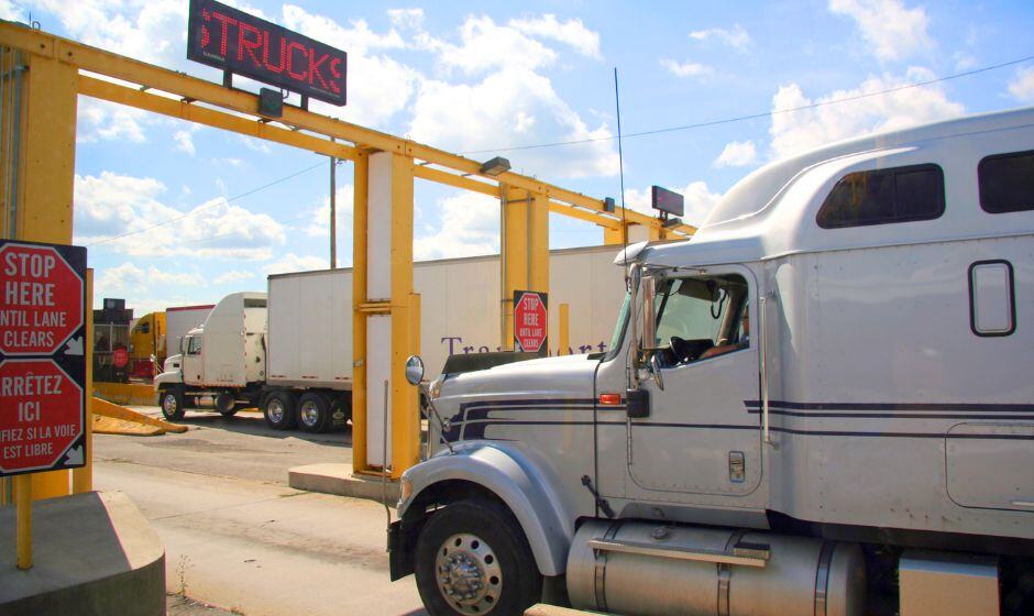 A truck carrying a freight shipment waits at the Canadian border