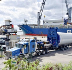 Wind towers being unloaded from a breakbulk vessel