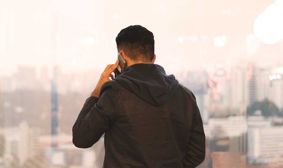 Man-on-cell-phone-facing-away