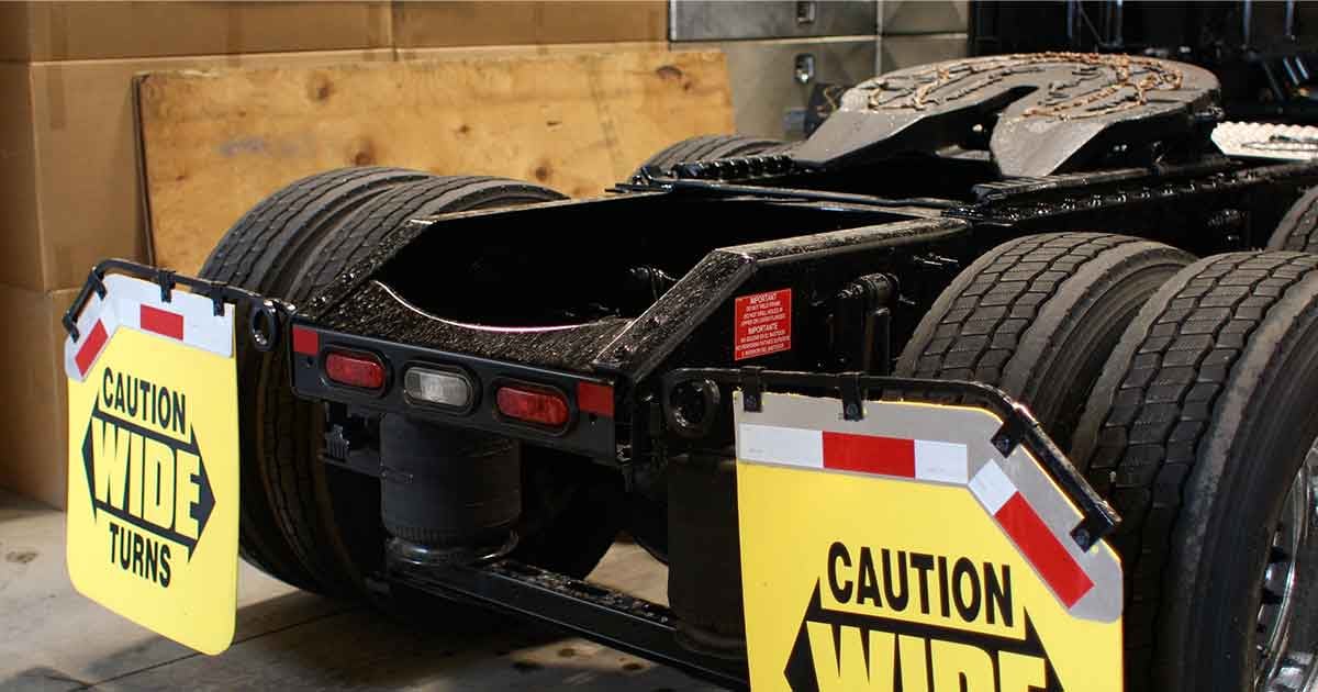 Rear wheels of semi tractor parked in shop
