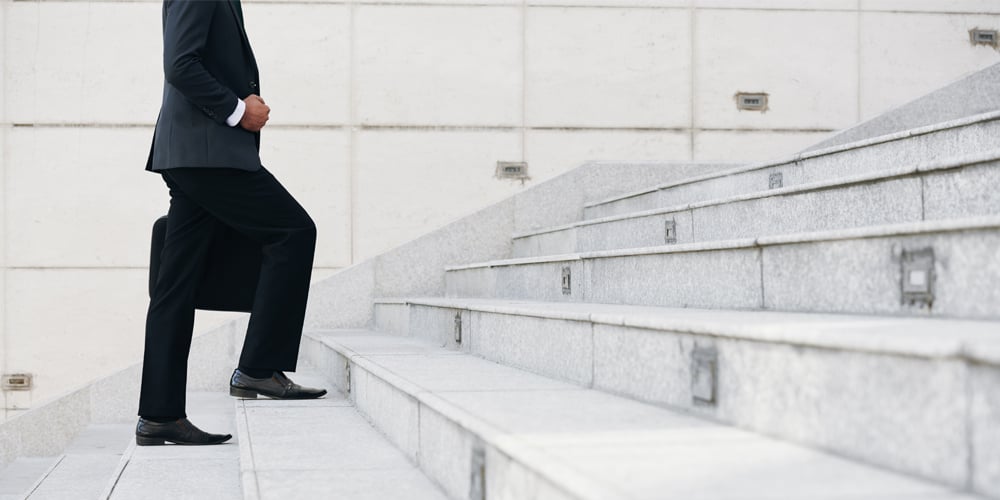 Man walking up stars representing career growth