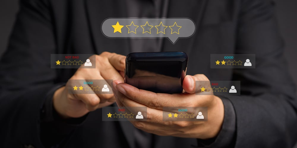 Person on phone leaving one-star review