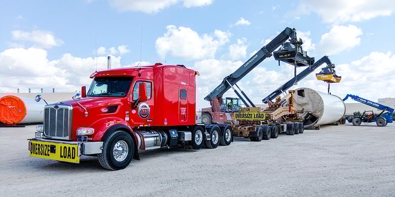 An ATS truck is loaded with a heavy haul load of machinery and equipment.