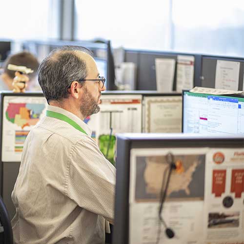 ATS Logistics employee at desk