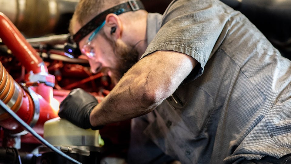 Diesel-Technician-Working-on-Engine