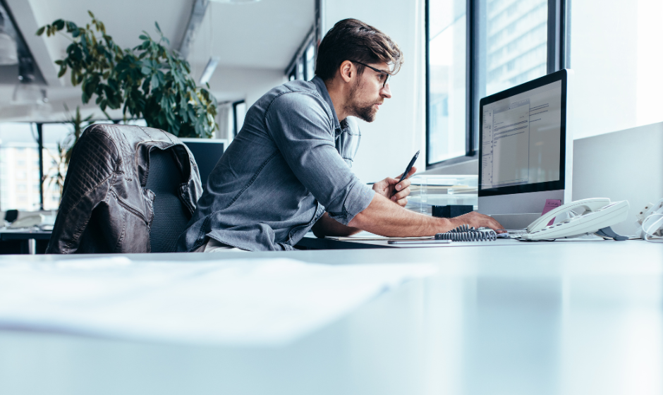 A man tracks a shipment on the computer