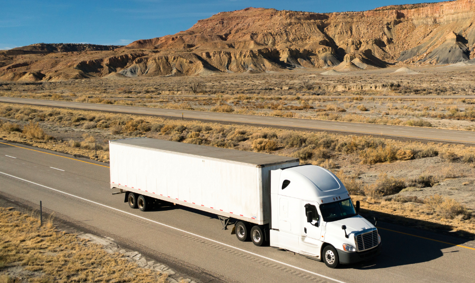 Semi truck and semi trailer traveling in the desert