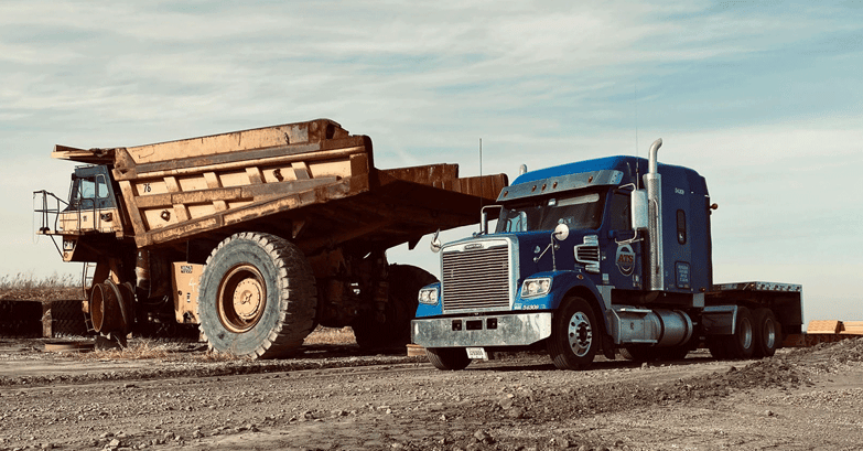 Semi-Truck-Next-to-Construction-Machinery-on-Job-Site