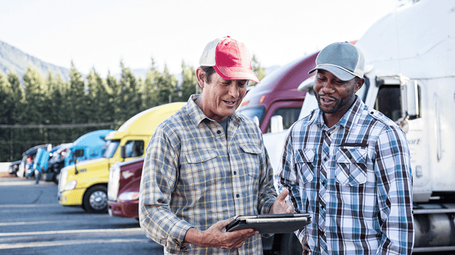 Two-Truck-Drivers-Talking-in-Lot