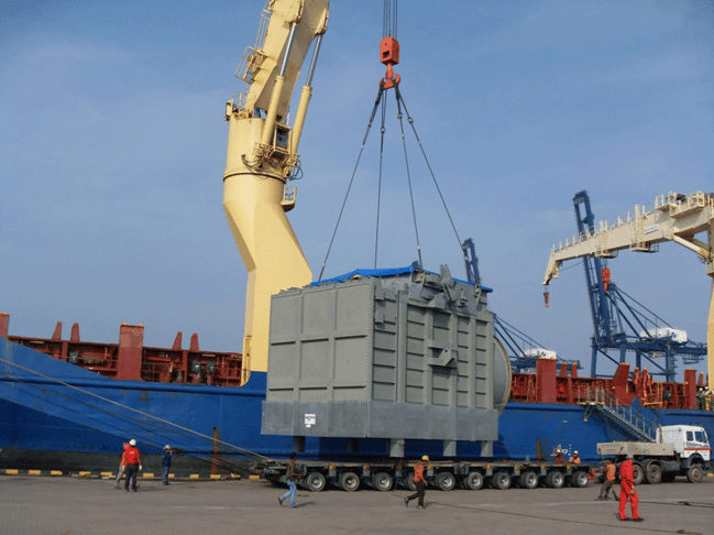 A breakbulk shipment is loaded using a heavy-lift crane.