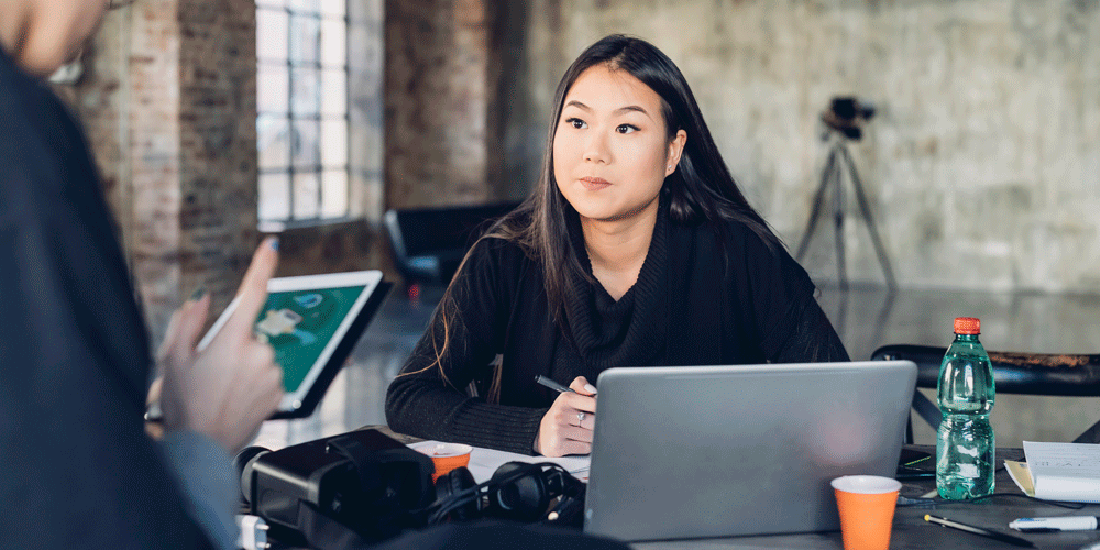 Design intern sitting at a desk in the studio.