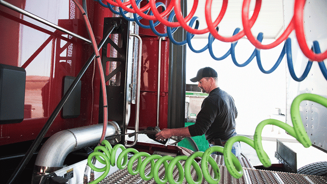 Truck-driver-filling-up-truck-with-diesel