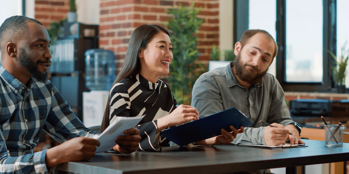 Three corporate recruiters sitting together smiling.
