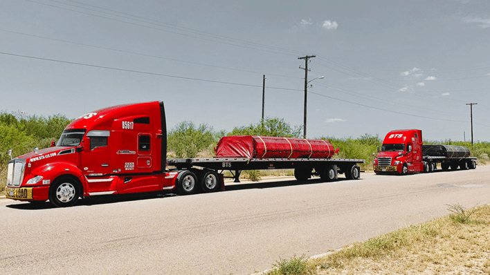two-flatbed-semi-trucks