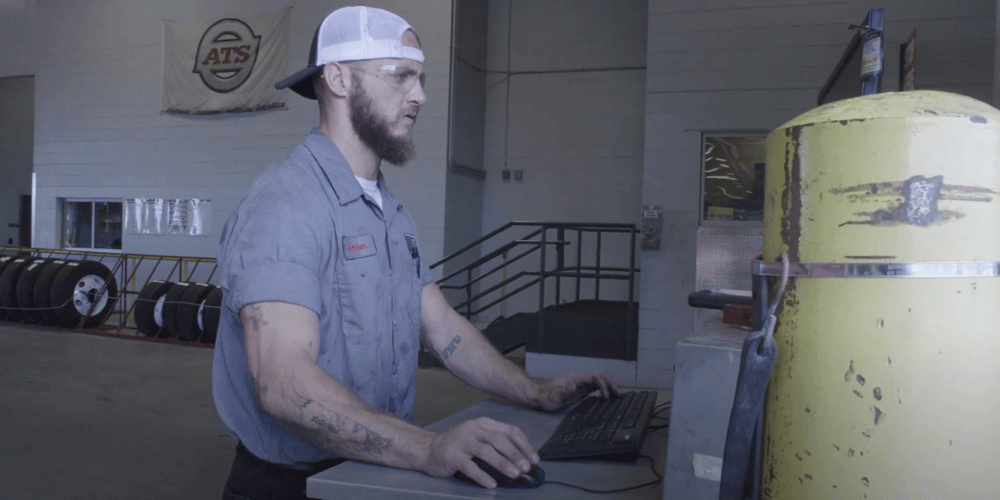 Mechanic on the computer in a shop.