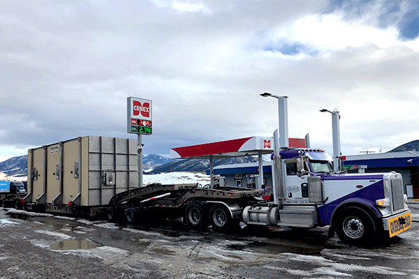 7 axle semi truck hauling heavy machinery