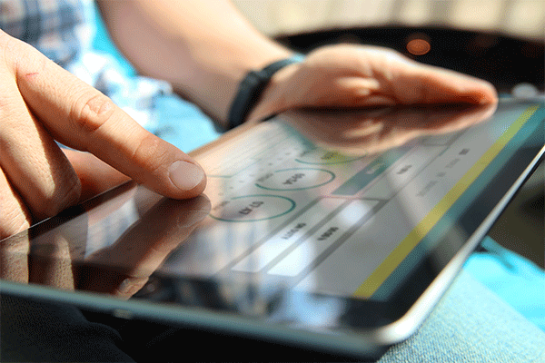 A shipper uses a digital customer portal on a tablet.