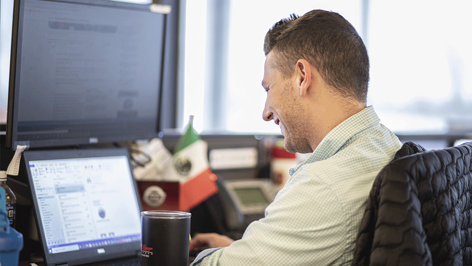 ATS Logistics sales person sitting at computer