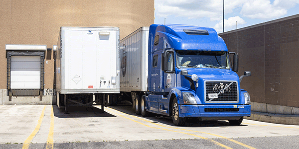 Dry van trailers await loading at a distribution center