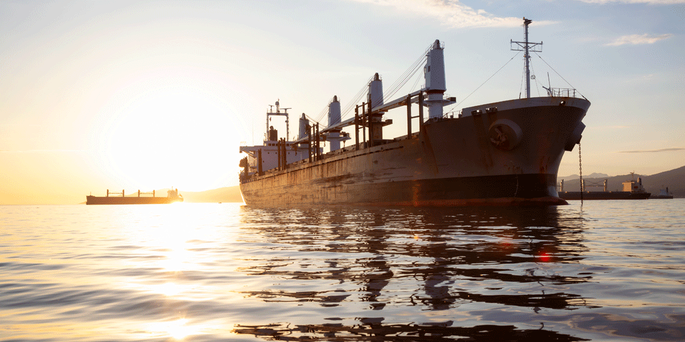 Old, rusty ship approaching port.
