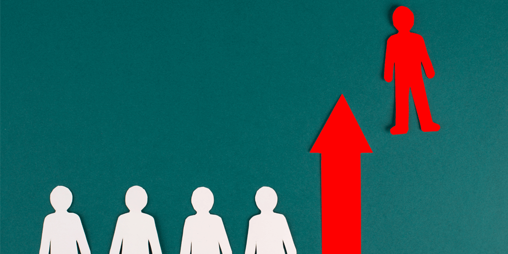 Stand out from the crowd concept with all white figures and a red one.