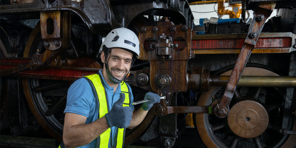 Diesel mechanic working on train engine.